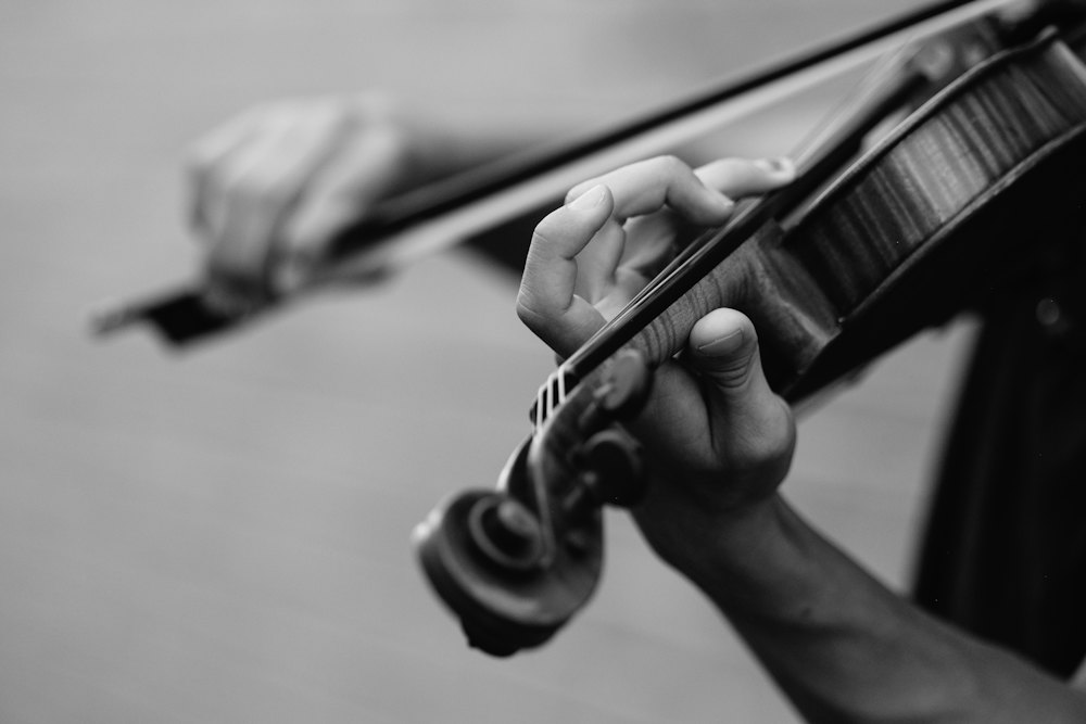A violinist’s hands and bow, mid-phrase